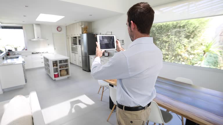 Real estate agent recording a video of a house using a tablet computer