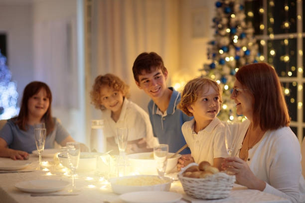 istock Christmas dinner. Family with kids at Xmas tree. 1447511722