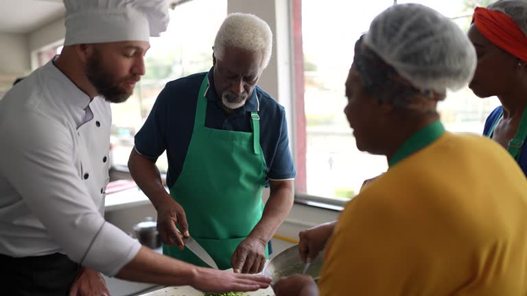 Chef teaching students during cooking class