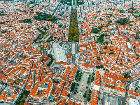 Overhead top down birds eye aerial view of patterns of red rooftops of traditional houses with narrow streets in Lisbon city center