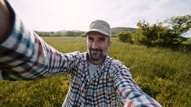 istock Farmer vlogging in wheat crops at sunset in spring. 1447523609