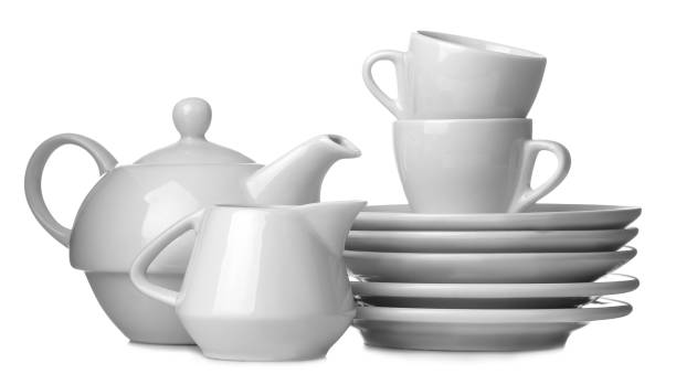 istock A stack of dishes. Dinnerware. plates, kettle and cup on a white isolated background. close-up. 1447524797