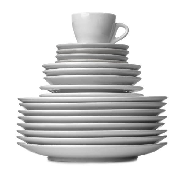 A stack of dishes. Dinnerware. plates and cup on a white isolated background. close-up.