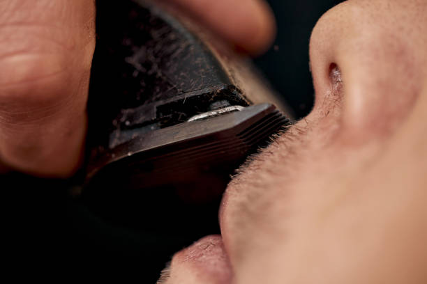 istock Barber shaving caucasian man in barber shop 1447525075