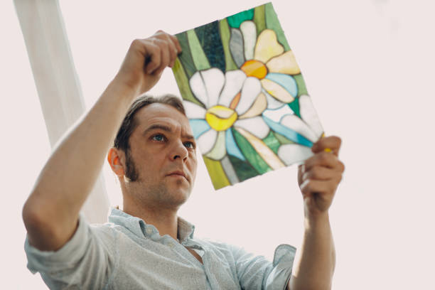 istock Restorer master male checking stained glass window project. 1447526032