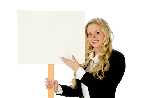 Young blond female in black suit isolated on white background