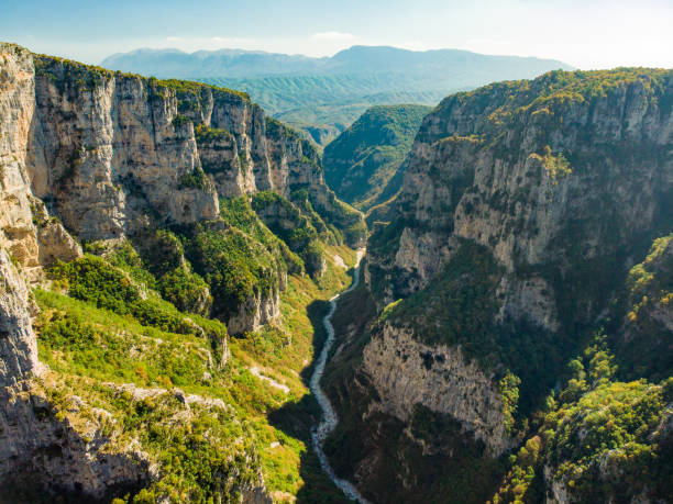 Vikos Gorge, a gorge in the Pindus Mountains of northern Greece, lying on the southern slopes of Mount Tymfi, one of the deepest gorges in the world. Aerial view of Vikos Gorge, a gorge in the Pindus Mountains of northern Greece, lying on the southern slopes of Mount Tymfi, one of the deepest gorges in the world. Zagori region, Greece. zagori stock pictures, royalty-free photos & images