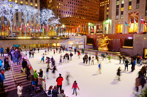 NEW YORK - MARCH 18, 2015: Tourists and new yorkers skate in the famous Rockefeller Center skating rink, New York City, USA.