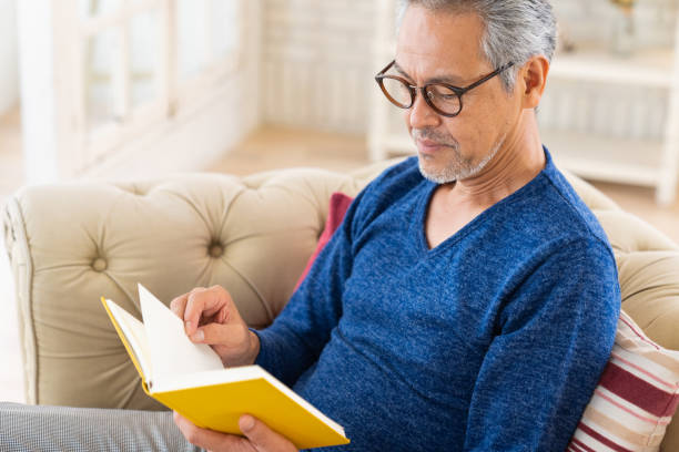 istock elderly man who reads a book, 1447531685