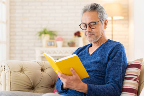 istock elderly man who reads a book, 1447531758