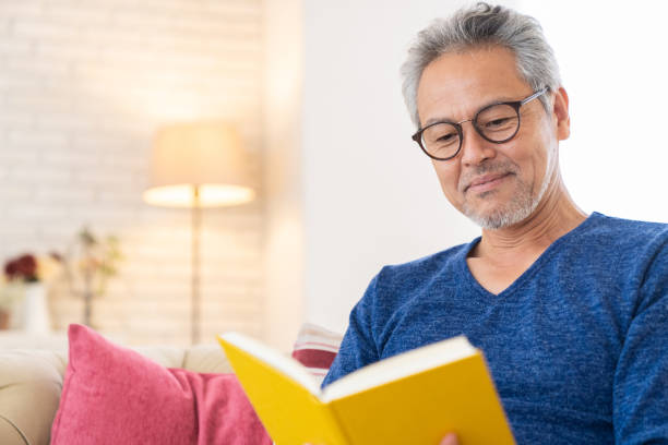 istock elderly man who reads a book, 1447531781