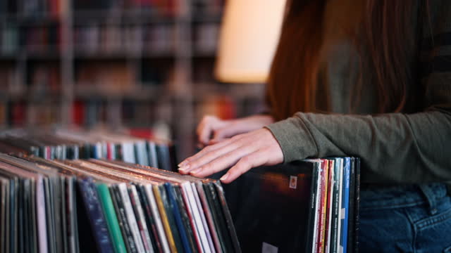 Woman hands browsing records in the vinyl record store