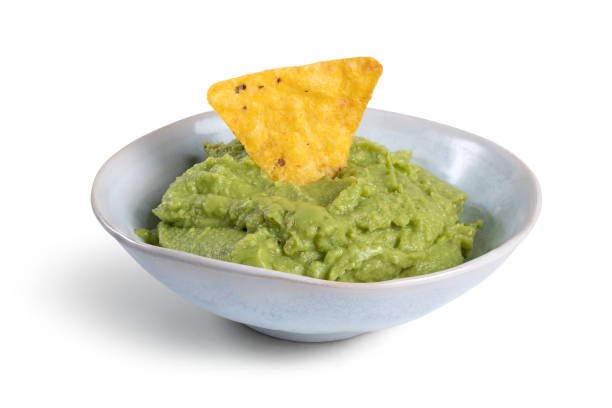 istock bowl with guacamole and nachos isolated on the white background 1447535446