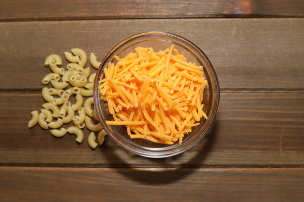 A bowl of shredded cheese on a table