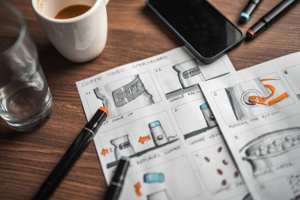 Storyboard Editors Table; Coffee, Colored Pencils And A Smartphone