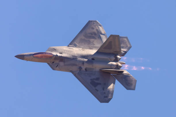 istock F-22 Raptor in a turn in beautiful light ,  with afterburners on 1447537948