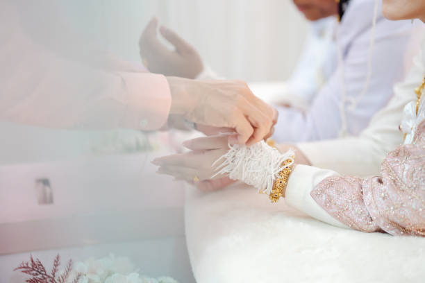istock Thai wedding ceremony. Wrist tying for Thai weddings. 1447552675
