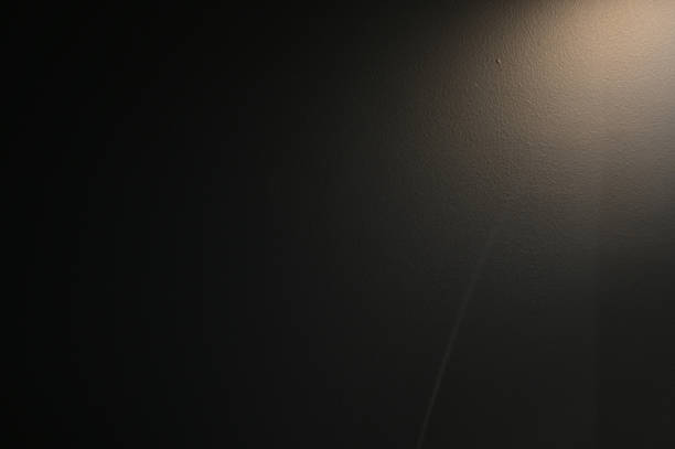 istock brown wall background with lights and black shadow 1447553494