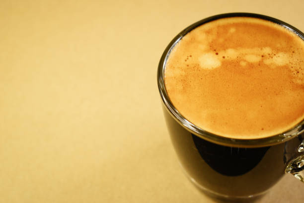 A glass of cappuccino flavored coffee on a white background