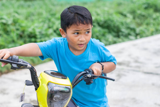 istock boy riding electric bikes in residential area 1447554894