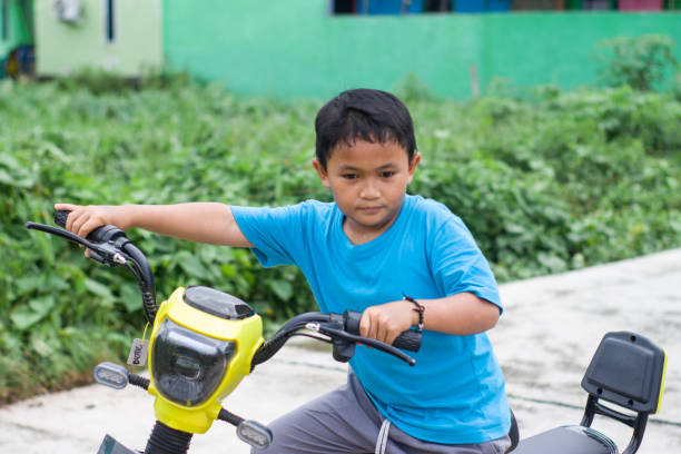 istock boy riding electric bikes in residential area 1447555110