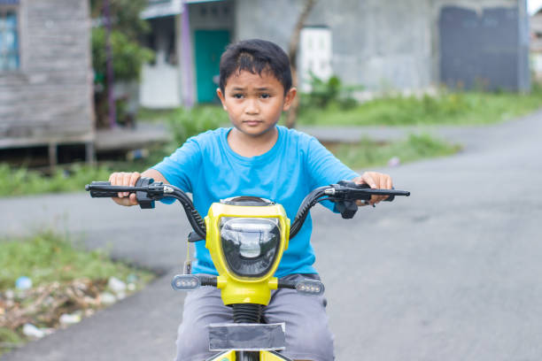 istock boy riding electric bikes in residential area 1447559568