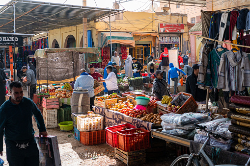 Rissani, Errachidia Province, Morocco - November 24, 2022: Sellers and buyers in a typical Arabian street market.