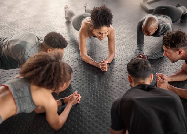 fitness, plank and gym people in a circle for exercise, motivation and floro exercise, cardio and strong. personal trainer, push up and group in a strength challenge for cross, health and fit workout - rivalidade imagens e fotografias de stock