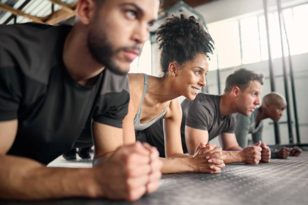 istock Teamwork, plank exercise or diversity gym for collaboration, motivation or wellness training, workout or fitness. Friends, team or athlete in studio on floor for health, cardio or sport muscle goal 1447563201