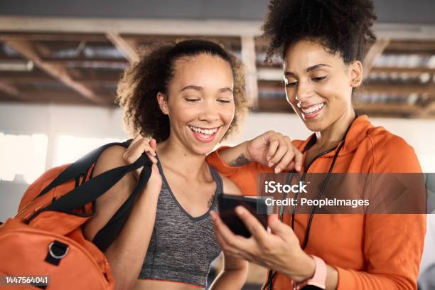 Phone Fitness And Friends Or Athlete Checking His Social Media After A Workout Or Exercise At The Gym Training Mobile And Health With Black Woman Tracking Their Cardio Progress On An Internet App Stock Photo - Download Image Now