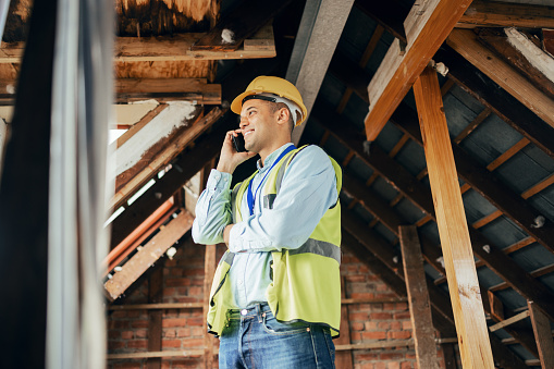 Architecture, construction and phone call with male architect planning a building project with communication. Engineer, man and cellphone conversation for construction worker home renovation project