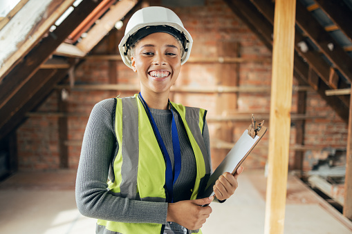 Architect woman, clipboard and happy on construction site in industry, planning and inspection. Engineer, architecture and construction worker smile at industrial workplace in building, house or home
