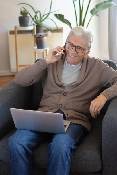 istock Smiling senior freelancer working at home 1447565467