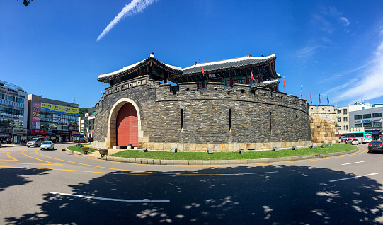 Hwaseong, Suwon, Korea - 09 13 2019:  The south gate of world heritage site: Hwaseong Fortress. The street and road for transportation and local traffic are around.