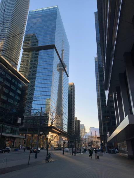 istock Toronto Downtown - CN Tower reflecting on blue glass skyscraper 1447566070