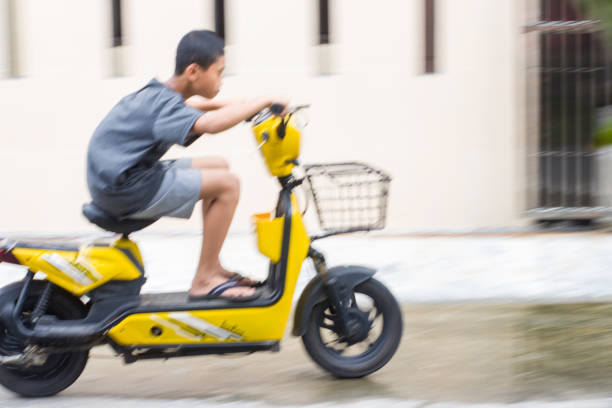 boy riding electric bikes in residential area