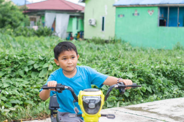 istock boy riding electric bikes in residential area 1447571531