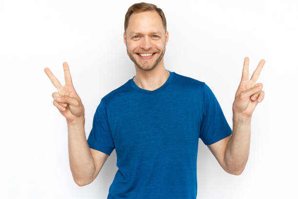istock Caucasian man showing peace signs at camera 1447573567