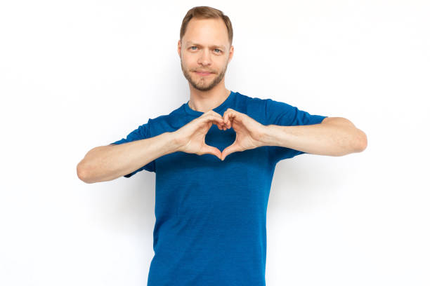 istock White man showing heart shape with hands at camera 1447573671