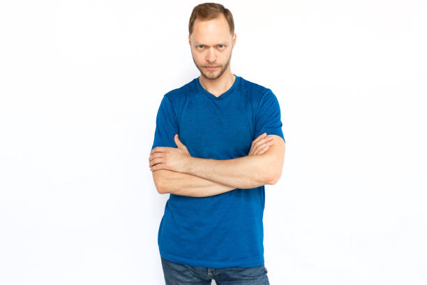 istock Serious man standing with folded arms and looking at camera 1447573682
