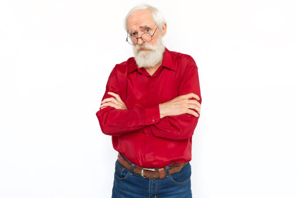 istock Confused senior man crossing arms 1447573787