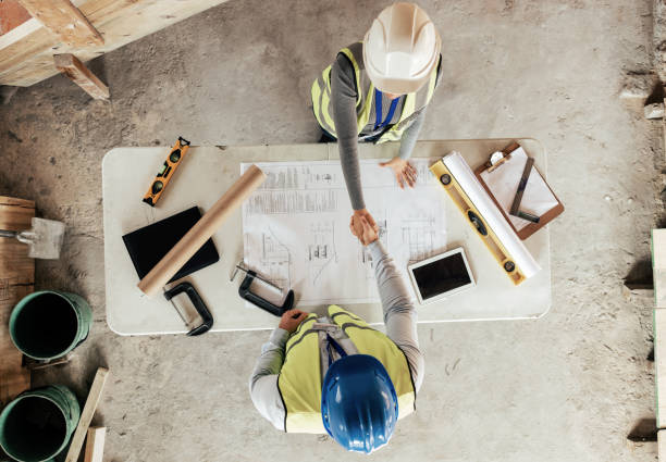 istock Architect, handshake and thank you for construction, blueprint and collaboration on building design. Architecture, engineering and worker shake hands, welcome and b2b with floor plan and top view 1447581927