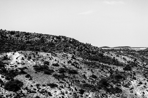 A grayscale shot of rural areas with patches of snow in Mexico