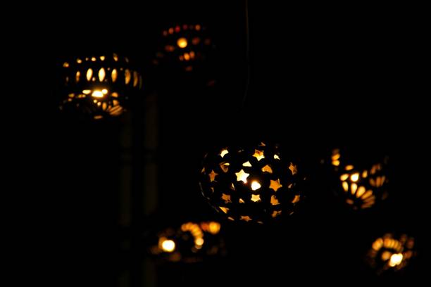 istock Beautiful lamps with various shaped cutouts in the dark 1447586068