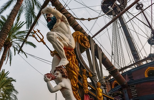 A Neptune statue on a galleon in the port of Genoa, Italy