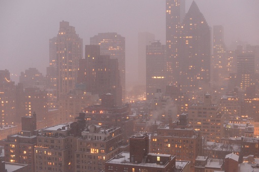 Winter in New York. High buildings illuminating the city in a cold and foggy weather