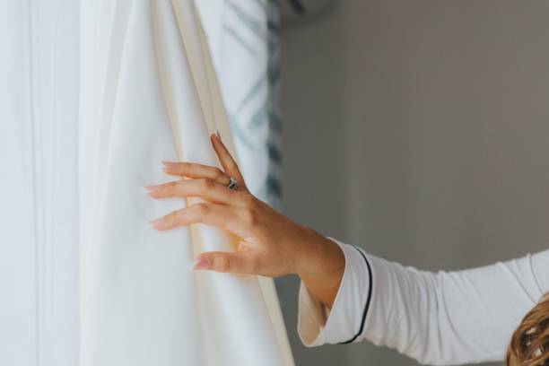istock Closeup of a bride's hand on a white blind. 1447588840