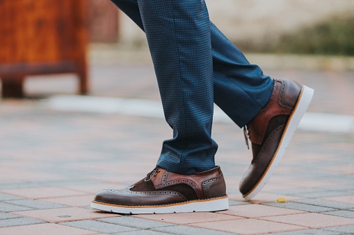 A close-up shot of a man wearing brown leather shoes