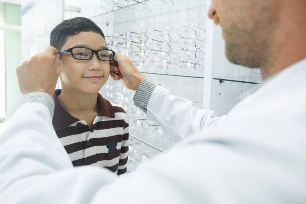 istock Smart young boy trying out new eyeglasses. 1447590738