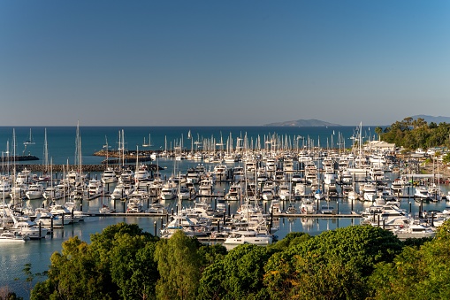 Airlie Beach, Australia – August 20, 2022: The crowded port of Airlie beach marina with anchored boats and yachts captured at sunset